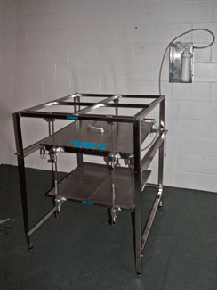 Stainless steel Series MIL-DBX Military Drip Box frame with adjustable height and ceiling-mount capabilities for military-grade water testing.