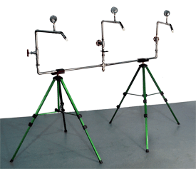 RTA-01 UL rain spray test apparatus on green tripods with a brown portfolio containing ISO 17025 accredited and NIST-traceable calibration documentation and a pile of RTS-01 plastic spray nozzles.