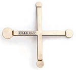 An overhead view of the CP-01 Coin Probe, a cross-shaped brass tool with four distinct circular probe ends and a central ED&D label, used to test shock hazard accessibility in household and audio/video products.